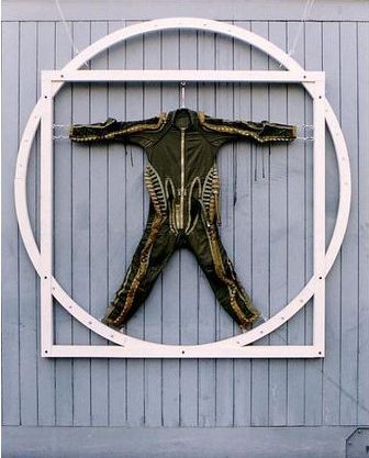 Human Proportions 1994. G-suit suspended in plywood construction relating to Leonardo's drawing, Vitruvian Man.