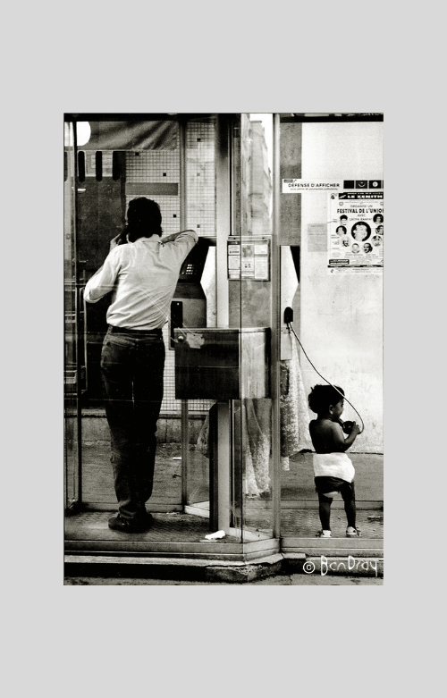 child mimics adult in Phone Box Paris 1989