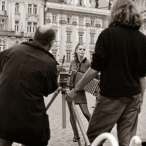 A beautiful girl is photographed during a fashion shoot in Old Town Square Prague 1995