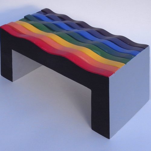 coffee table with a surface of waves in colours of the spectrum in the order of a rainbow.